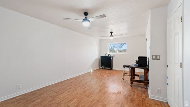 Home office with a ceiling fan, baseboards, and light wood-type flooring | Image 11