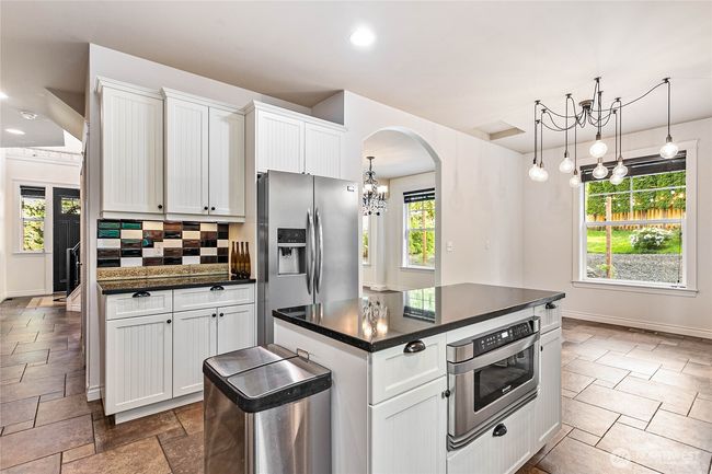 Looking across the kitchen back toward the entry and the kitchen dining area. | Image 6