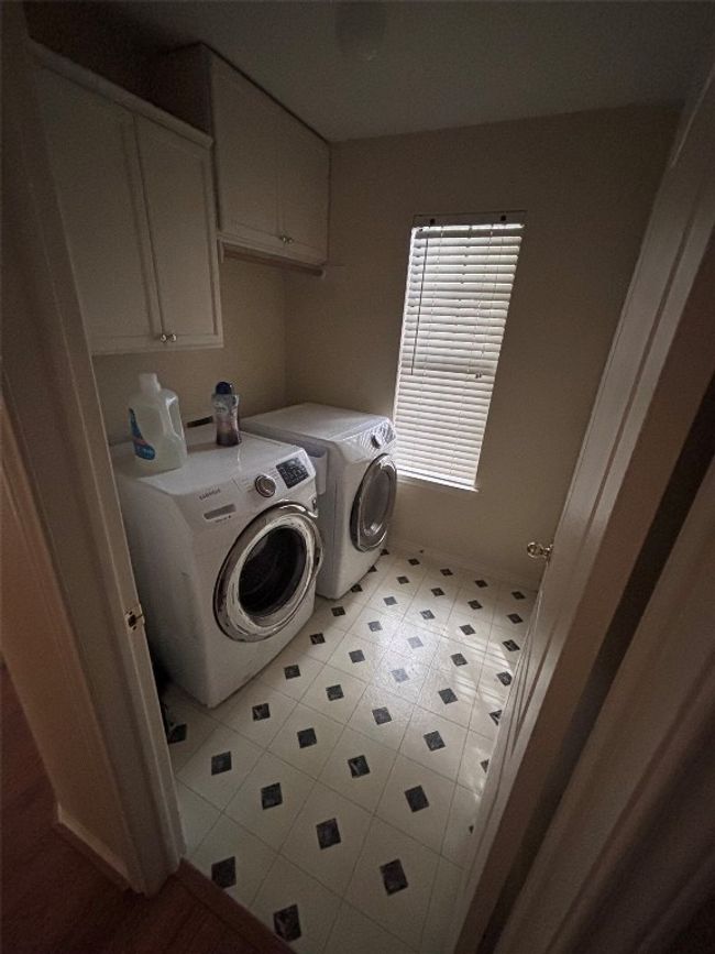 Laundry room featuring washing machine and dryer and cabinet space | Image 20
