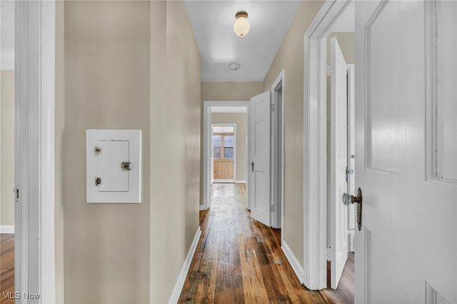 Corridor featuring baseboards and dark wood-style floors | Image 32
