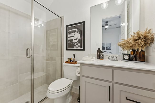 Bathroom with toilet, vanity, and a stall shower | Image 26