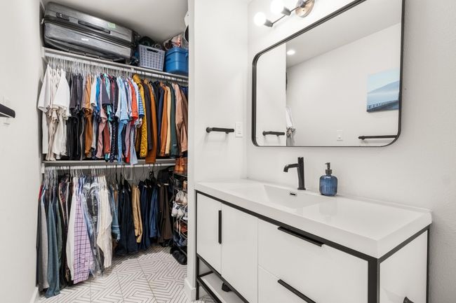 Bathroom featuring a walk in closet and vanity | Image 12