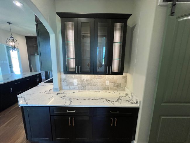 Butler area with lighted hutch and arched walkways | Image 12