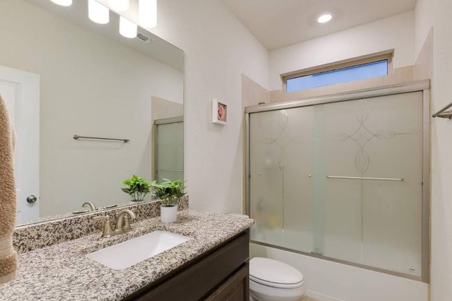 Bathroom with vanity, toilet, and enclosed tub / shower combo | Image 16
