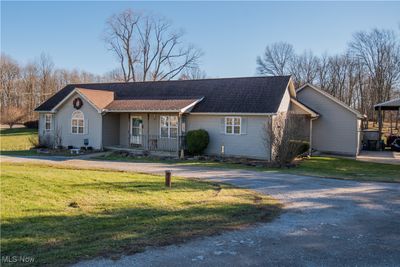 Ranch-style Home featuring a front yard and circular driveway. 3 Car attached garage. | Image 1