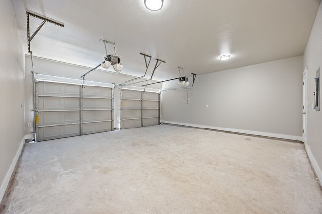 Garage with a garage door opener and baseboards | Image 23