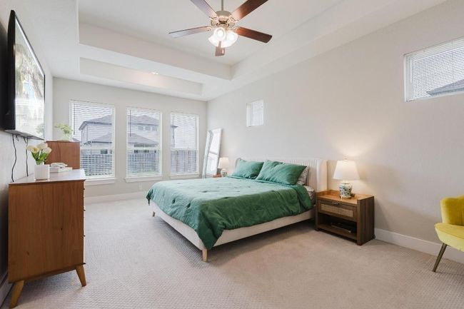 Spacious primary suite with additional windows over bed | Image 14