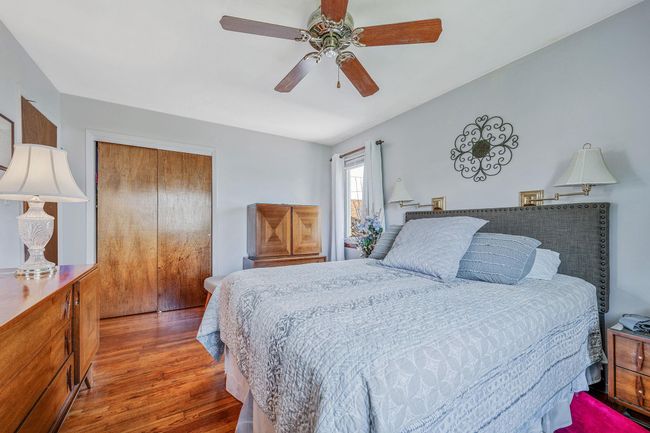 Bedroom featuring a closet, wood finished floors, and a ceiling fan | Image 16