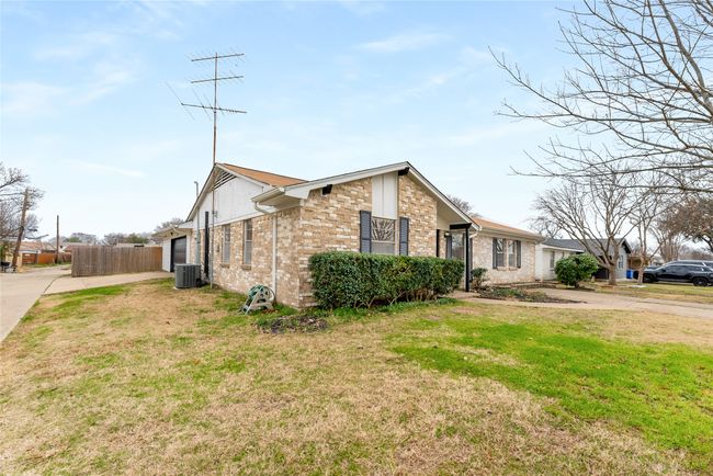 View of front of home with central AC unit and a front lawn | Image 5
