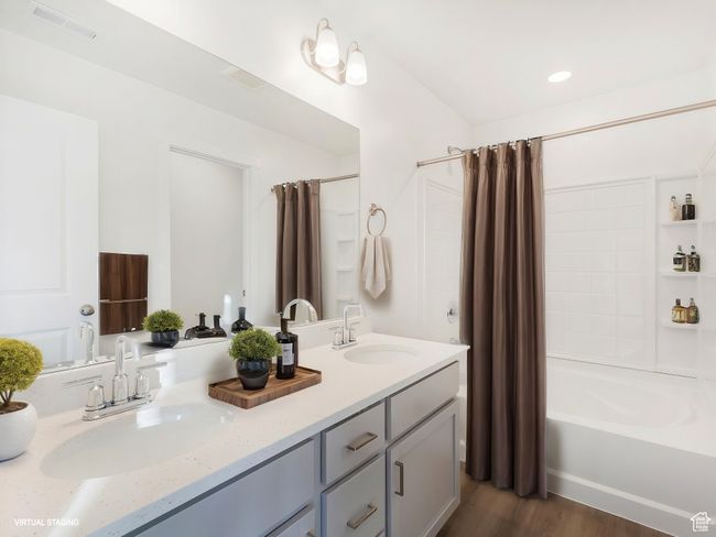 Full bathroom featuring shower / tub combo with curtain, double vanity, and wood finished floors | Image 4