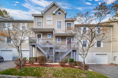 View of front facade featuring covered porch and a garage | Image 1