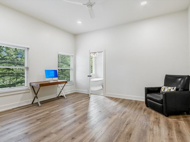 Sitting room featuring light wood-style flooring, baseboards, ceiling fan, and a wealth of natural light | Image 11