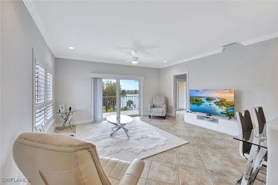 Large Living area with views out to balcony and the bay | Image 2