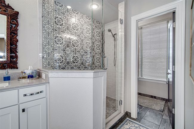 Full bath featuring baseboards, a stall shower, and vanity | Image 34