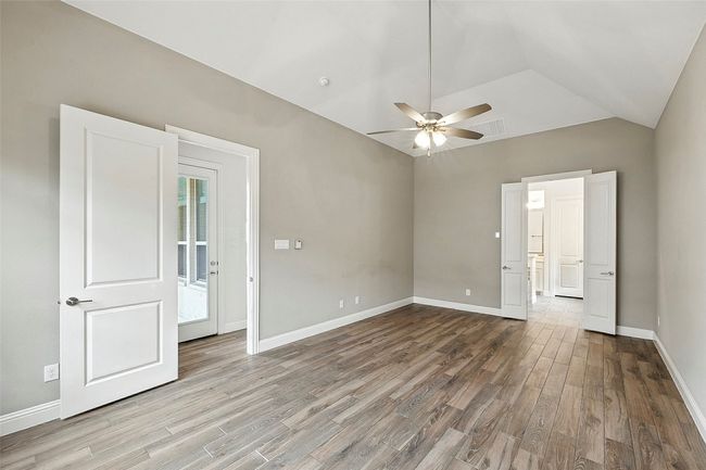 Unfurnished bedroom featuring tile floors, lofted ceiling, and a ceiling fan | Image 19