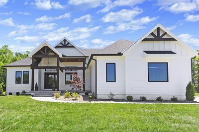 Modern inspired farmhouse featuring a front yard | Image 1