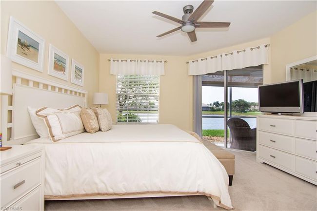 Primary bedroom suite offers a peaceful sanctuary with sliding glass doors to your screened lanai. | Image 17