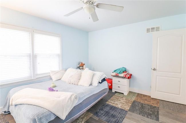 Bedroom with a ceiling fan and baseboards | Image 29
