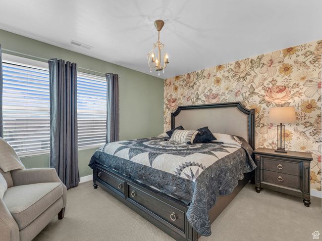 Bedroom 2 with carpet floors, wallpapered wall, and a chandelier | Image 31