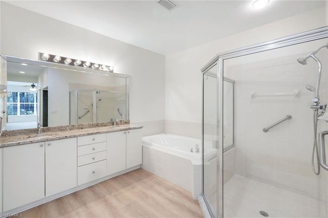 Full bath with a shower stall, double vanity, a bath, a sink, and visible vents | Image 11