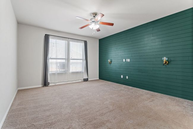 Empty room featuring baseboards, ceiling fan, carpet floors, and an accent wall | Image 22