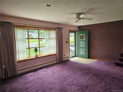 pretty room with plenty of natural light. Hard wood under carpet | Image 2