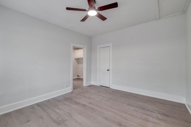 Unfurnished room with ceiling fan and light wood-style floors | Image 11
