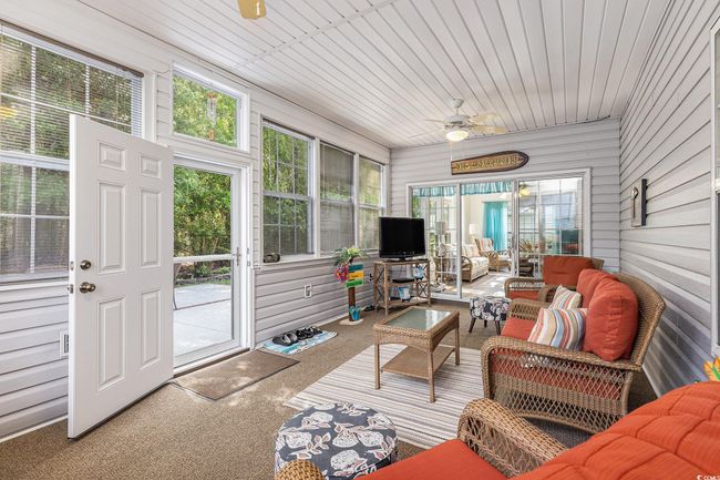 Sunroom featuring outdoor lounge area, healthy amount of natural light, and ceiling fan | Image 35