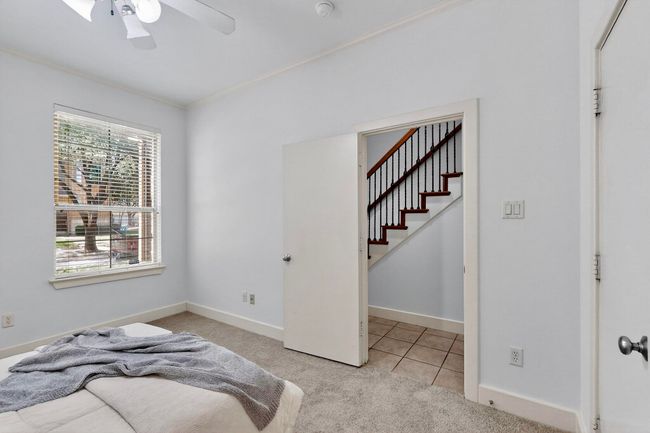 Bedroom featuring carpet flooring, crown molding, tile patterned floors, and ceiling fan | Image 29