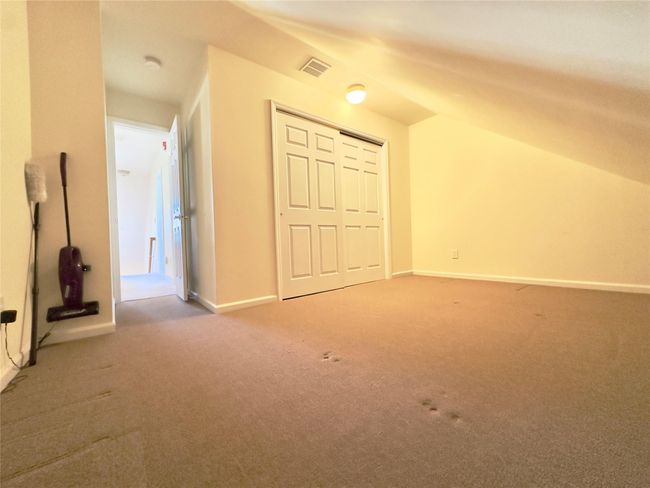 2nd floor Additional living space, Bedroom / Office featuring lofted ceiling, baseboards, visible vents, and carpet flooring | Image 15
