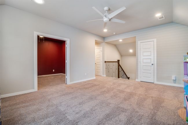 Carpeted empty room featuring lofted ceiling, a ceiling fan, and recessed lighting | Image 19