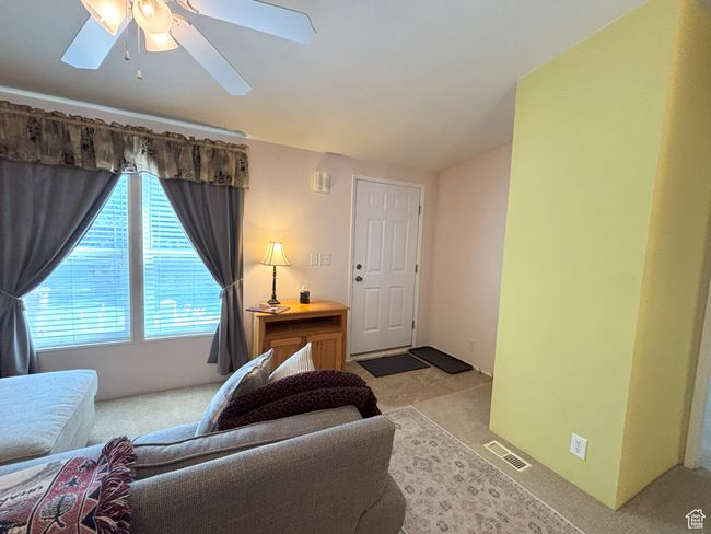 Bright living room and front door. | Image 21