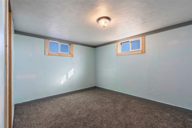 Bright lower-level room with multiple windows for natural light. | Image 53