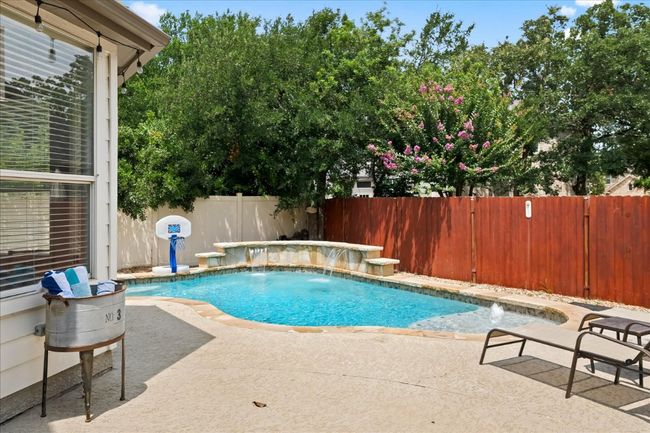 View of swimming pool with a patio area, a fenced backyard, and a fenced in pool | Image 25