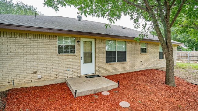 Back of property with brick siding and roof with shingles | Image 4