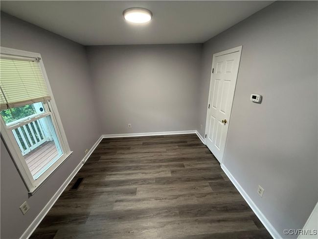 Unfurnished room with baseboards and dark wood finished floors | Image 13
