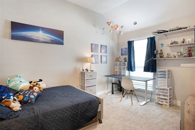 Carpeted bedroom featuring lofted ceiling and baseboards | Image 14