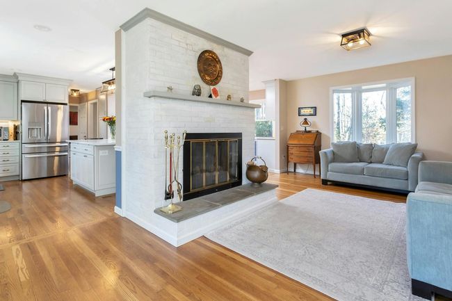 The family room with fire place and elegant bay window is the perfect space to relax. | Image 9
