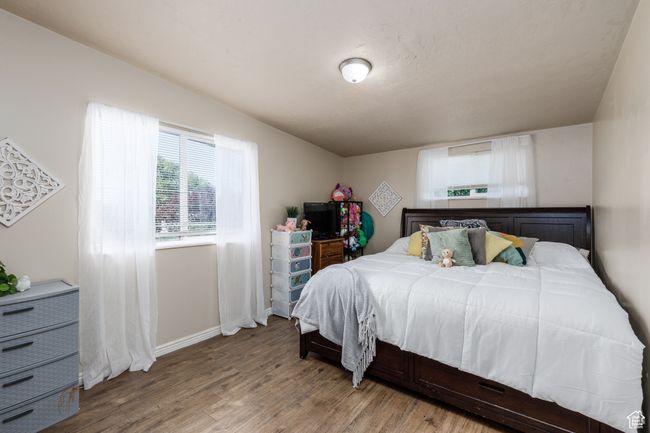Bedroom with wood finished floors and baseboards | Image 14