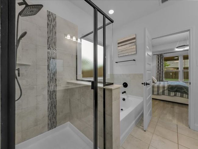 Bathroom with a shower stall, ensuite bathroom, and tile patterned flooring | Image 21