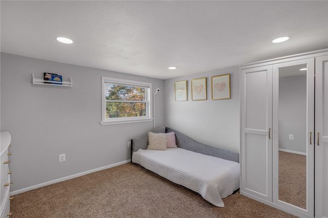 Upper guest bedroom overlooking front yard. Closet system stays. | Image 18