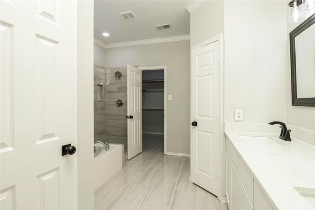 Bathroom with ornamental molding, double vanity, and baseboards | Image 12