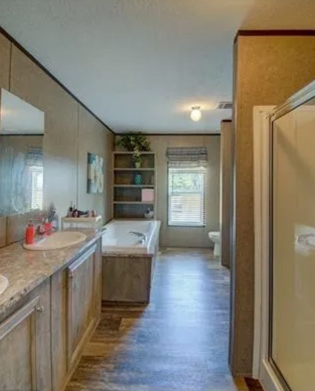 Full bath with a shower stall, a bath, double vanity, and wood finished floors | Image 12