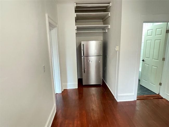 Kitchen with freestanding refrigerator, wood finished floors, and baseboards | Image 12