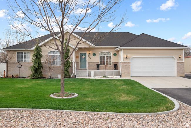 Ranch-style house with a front lawn, a garage, brick siding, and concrete driveway | Image 45