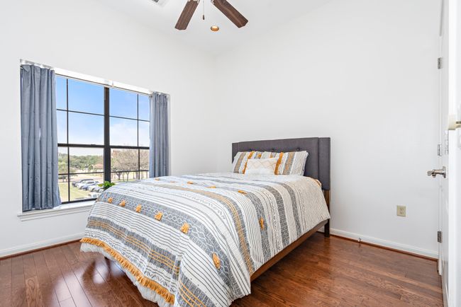 Bedroom with baseboards, hardwood / wood-style flooring, recessed lighting, and a ceiling fan | Image 9