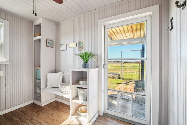 The spacious utility room - with a storm door to the front porch (with doggy door) and a secure door to the farmhouse behind you. Washer and Dryer convey. | Image 12