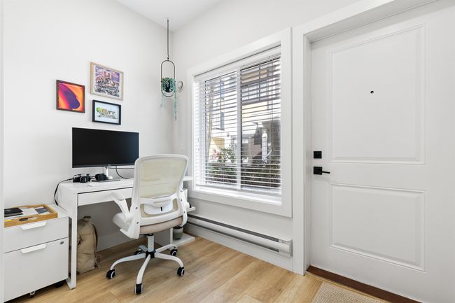 Office featuring light wood-style flooring and a baseboard radiator | Image 21