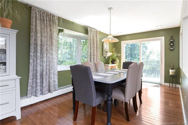Dining Room with sliders to large deck off of back as well as front balcony. | Image 7
