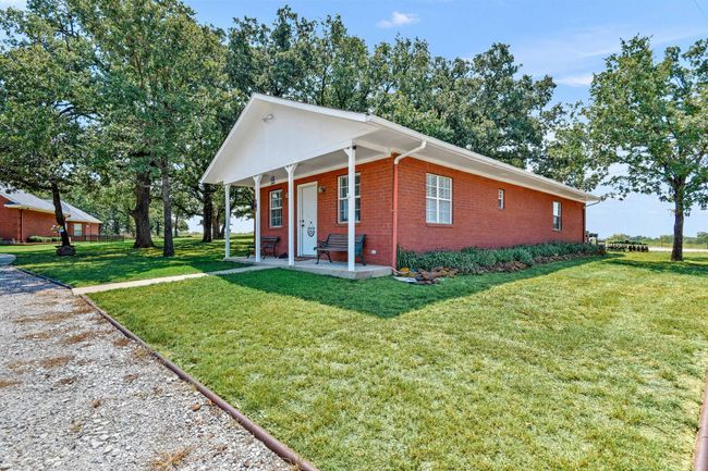Guest quarters/office with kitchenette and full bathroom. Large covered front porch. Has its own septic and irrigation system | Image 15